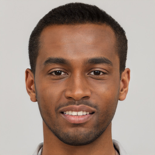 Joyful black young-adult male with short  brown hair and brown eyes