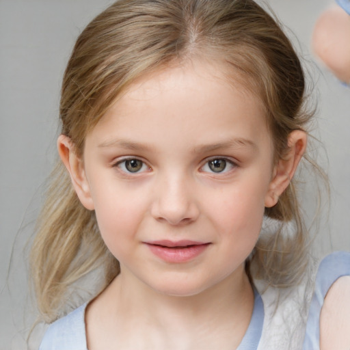 Joyful white child female with medium  brown hair and blue eyes