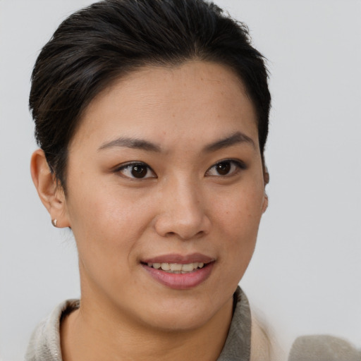 Joyful asian young-adult female with short  brown hair and brown eyes