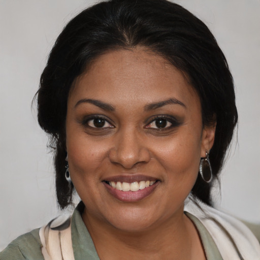 Joyful black young-adult female with medium  brown hair and brown eyes