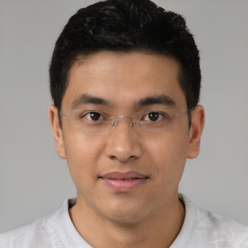 Joyful asian young-adult male with short  black hair and brown eyes