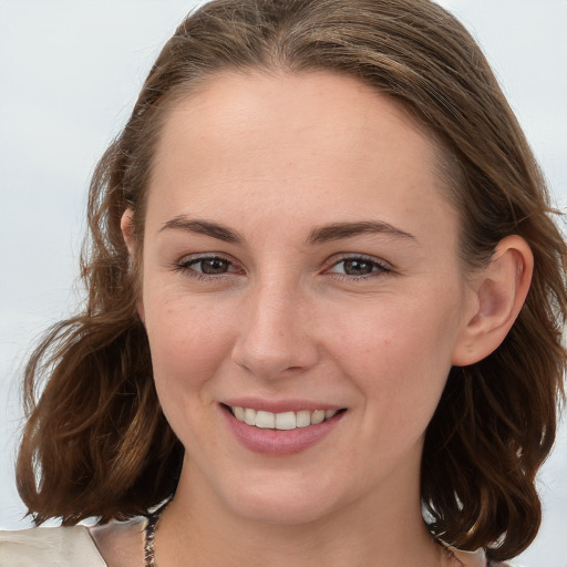 Joyful white young-adult female with medium  brown hair and blue eyes