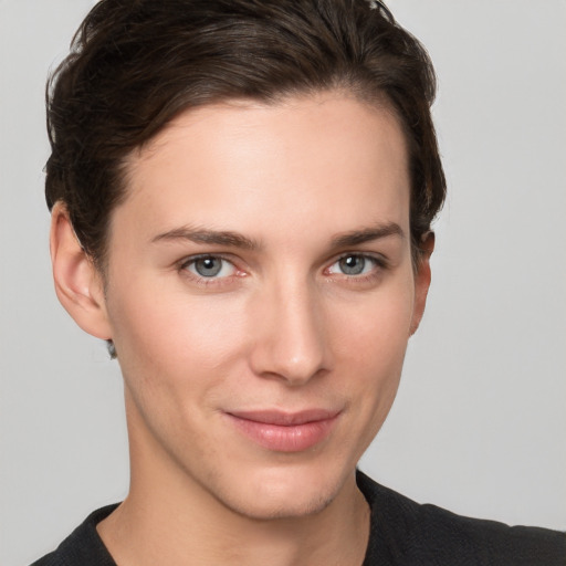 Joyful white young-adult female with short  brown hair and grey eyes