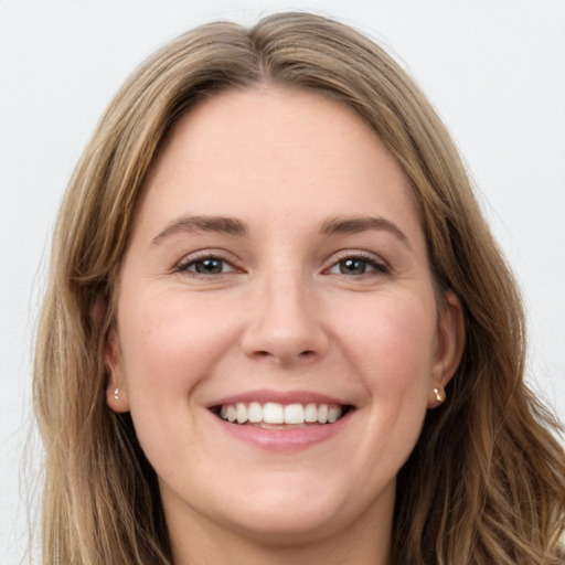 Joyful white young-adult female with long  brown hair and green eyes