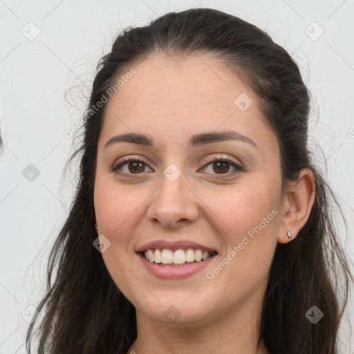 Joyful white young-adult female with long  brown hair and brown eyes