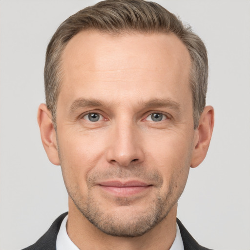 Joyful white adult male with short  brown hair and grey eyes