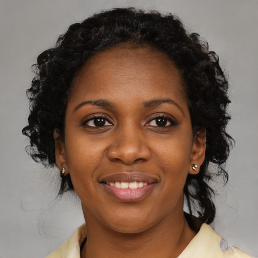 Joyful black young-adult female with medium  black hair and brown eyes