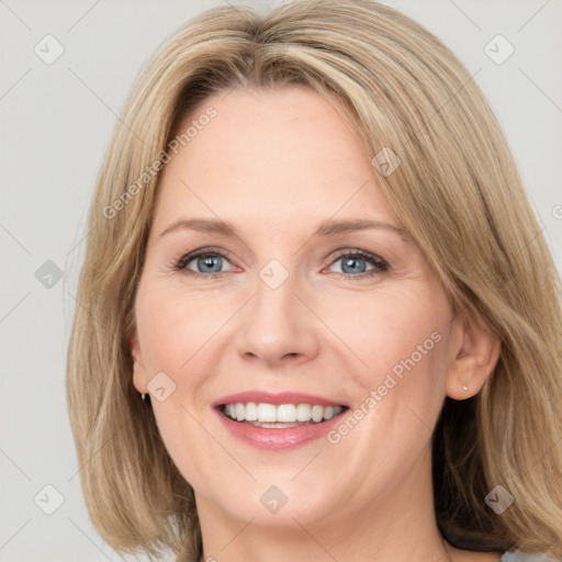 Joyful white adult female with medium  brown hair and grey eyes