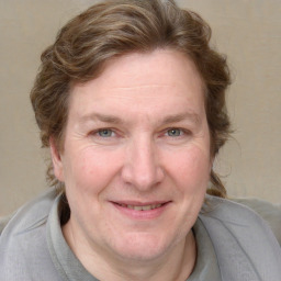 Joyful white adult female with medium  brown hair and blue eyes