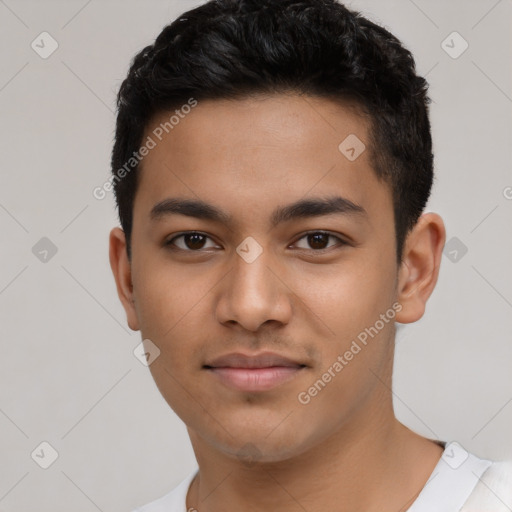 Joyful latino young-adult male with short  black hair and brown eyes