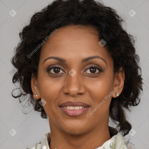 Joyful black adult female with long  brown hair and brown eyes