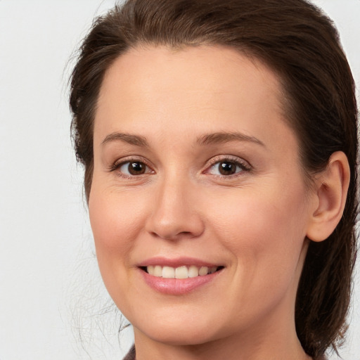 Joyful white young-adult female with medium  brown hair and brown eyes