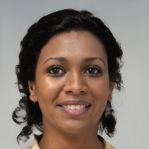 Joyful black young-adult female with medium  black hair and brown eyes