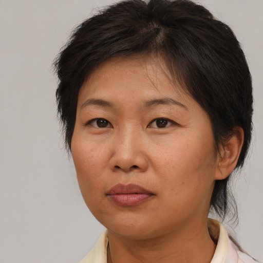 Neutral asian adult female with medium  brown hair and brown eyes
