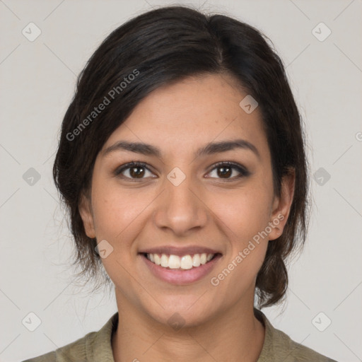 Joyful latino young-adult female with medium  brown hair and brown eyes