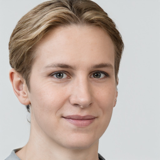 Joyful white young-adult female with short  brown hair and grey eyes