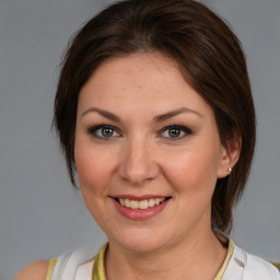 Joyful white adult female with medium  brown hair and brown eyes