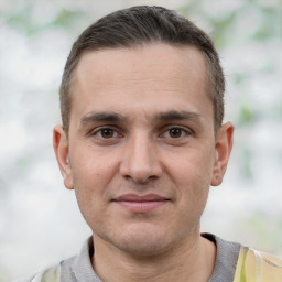 Joyful white young-adult male with short  brown hair and brown eyes