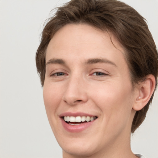 Joyful white young-adult female with short  brown hair and grey eyes