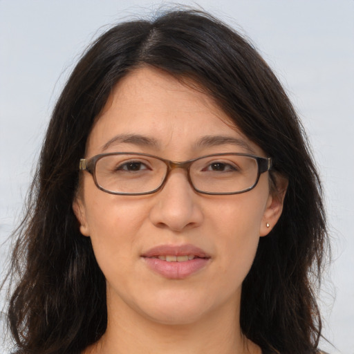 Joyful white adult female with long  brown hair and brown eyes