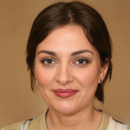 Joyful white adult female with medium  brown hair and brown eyes