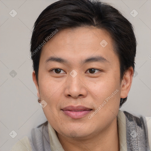 Joyful asian adult male with short  brown hair and brown eyes