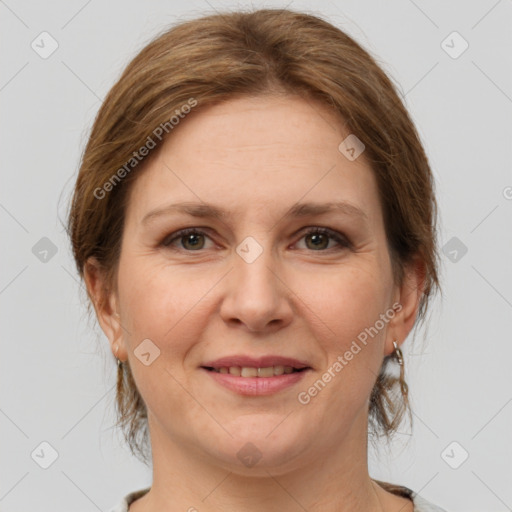 Joyful white adult female with medium  brown hair and grey eyes