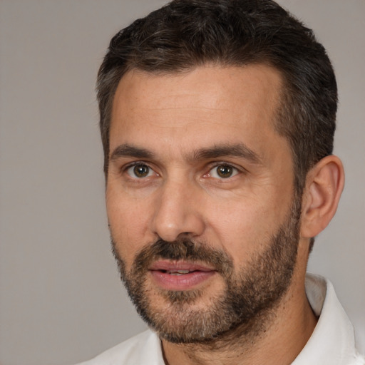 Joyful white adult male with short  brown hair and brown eyes