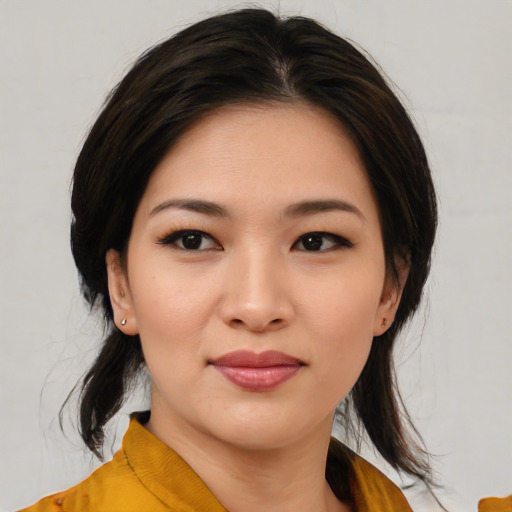 Joyful asian young-adult female with medium  black hair and brown eyes