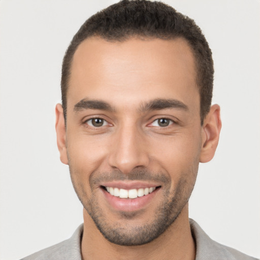 Joyful white young-adult male with short  brown hair and brown eyes