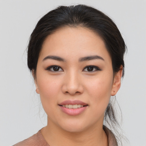 Joyful asian young-adult female with medium  brown hair and brown eyes
