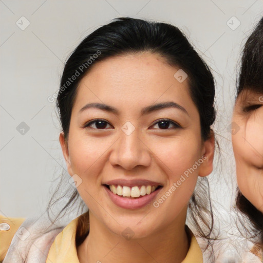 Joyful latino young-adult female with medium  brown hair and brown eyes