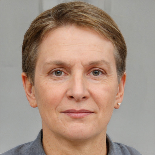 Joyful white adult female with short  brown hair and grey eyes