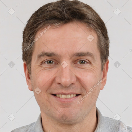 Joyful white adult male with short  brown hair and grey eyes