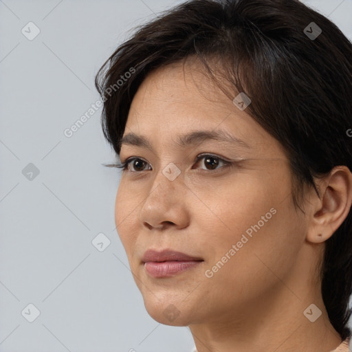 Joyful white adult female with medium  brown hair and brown eyes