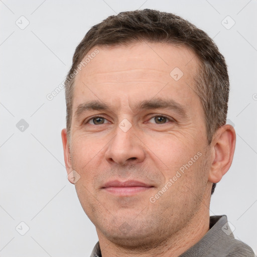 Joyful white adult male with short  brown hair and brown eyes