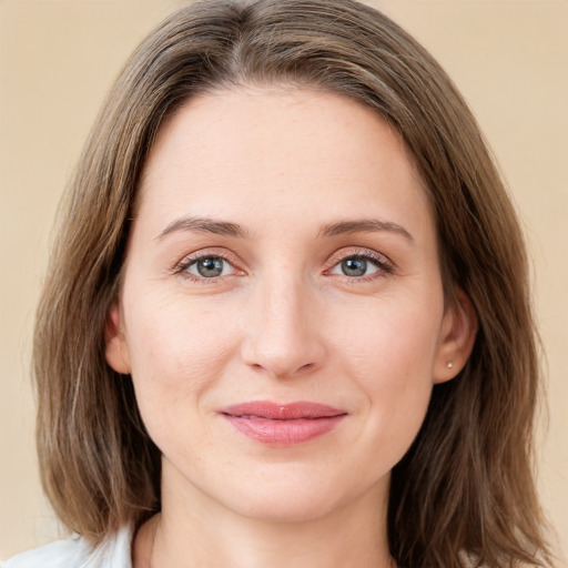 Joyful white young-adult female with medium  brown hair and green eyes