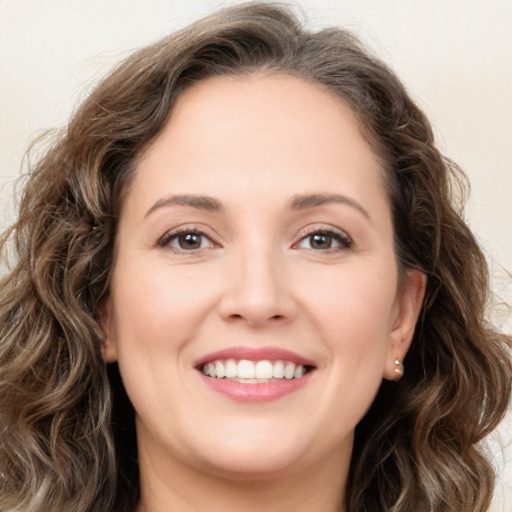 Joyful white young-adult female with long  brown hair and green eyes