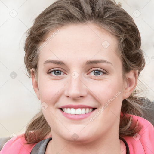 Joyful white young-adult female with medium  brown hair and blue eyes