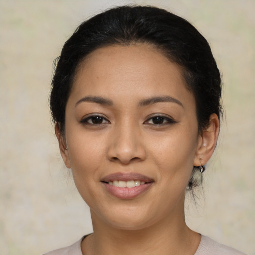 Joyful latino young-adult female with medium  black hair and brown eyes