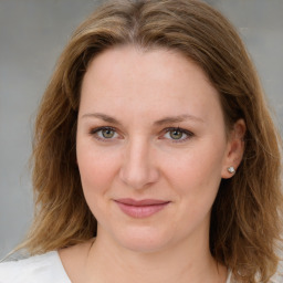 Joyful white young-adult female with medium  brown hair and blue eyes