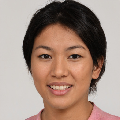 Joyful asian young-adult female with medium  black hair and brown eyes