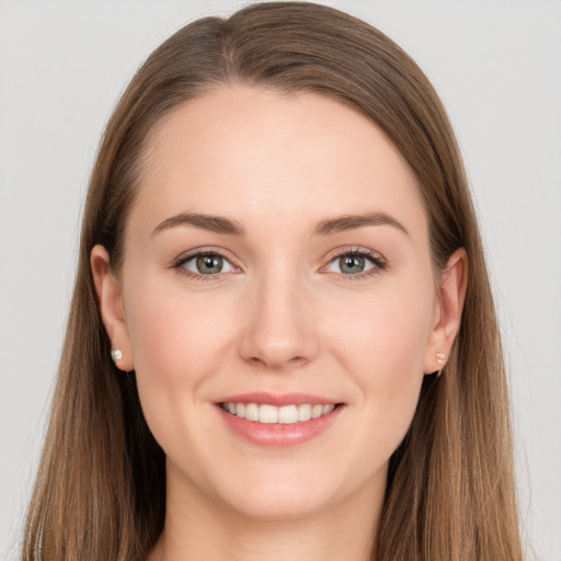 Joyful white young-adult female with long  brown hair and grey eyes