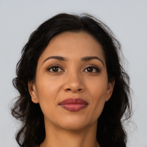 Joyful latino young-adult female with long  brown hair and brown eyes