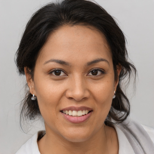 Joyful latino young-adult female with medium  brown hair and brown eyes