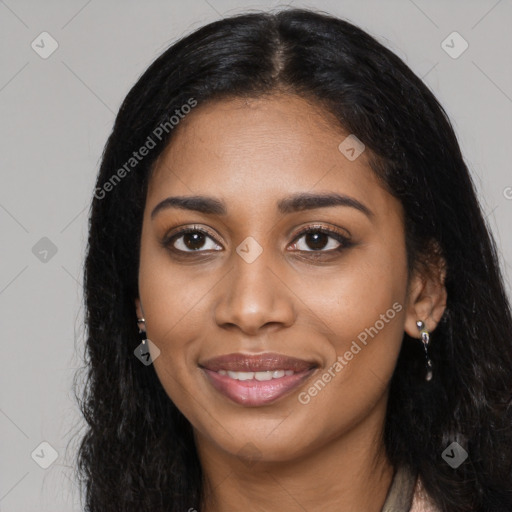 Joyful black young-adult female with long  black hair and brown eyes