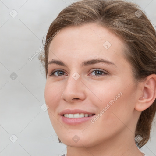 Joyful white young-adult female with medium  brown hair and grey eyes