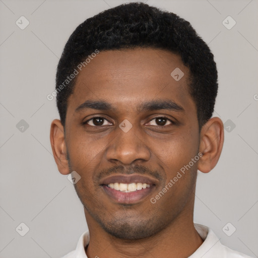 Joyful black young-adult male with short  black hair and brown eyes