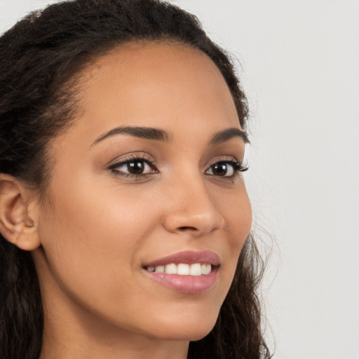 Joyful latino young-adult female with long  brown hair and brown eyes