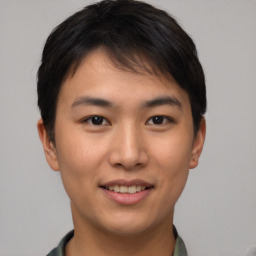 Joyful asian young-adult male with short  brown hair and brown eyes